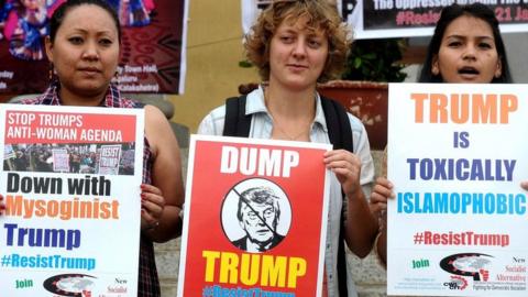 Members of New Socialist Alternative Indian section of the committee for the workers international fighting for Democratic Socialism holds placards and shouts slogans against the newly sworn United States of American President Donald Trump in Bangalore