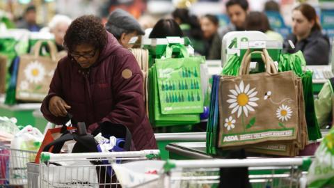 Woman seen near checkout in large Asda store