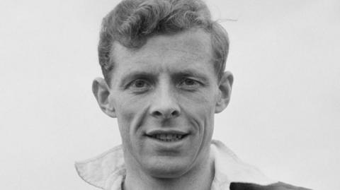 A black and white picture of rugby player Arthur Smith with curly hair