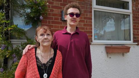 Lynne Antink and Colin Antink outside their bungalow.