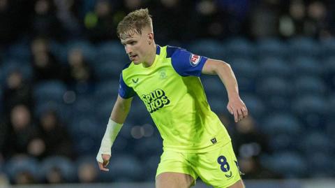 Ali McCann drives forward in possession for Preston North End against Blackburn Rovers