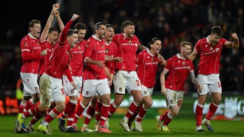 Wrexham players celebrate beating Nottingham Forest on penalties