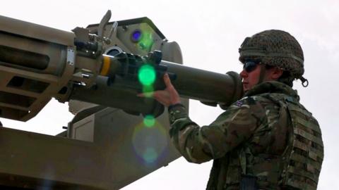 Soldier putting missile in tube