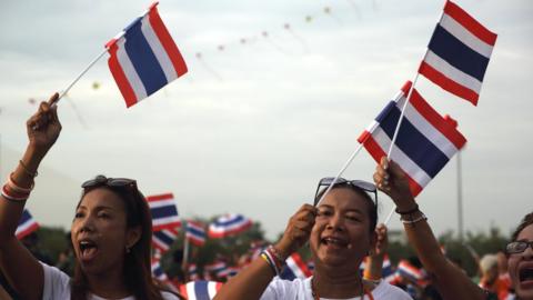 Women wave the Thai flag