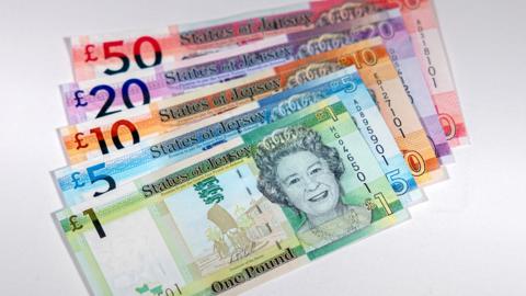 A collection of Jersey notes on a white backdrop. 