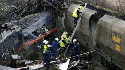 Emergency workers inspecting wreckage following collision at Great Heck in February 2001