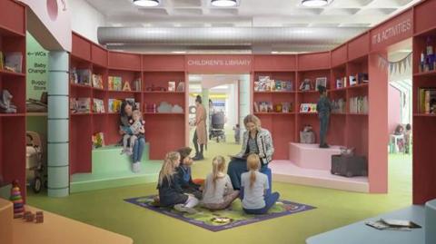 Artist's impression of the library's new children's zone. A woman with blonde hair is reading to four youngsters in the centre of the room. Behind them, a girl is sitting on her mother's lap as they read a book. The room has red walls and shelves, a green carpet and splashes of other colours.