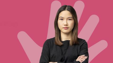 Woman folds her arm in front of a hand graphic