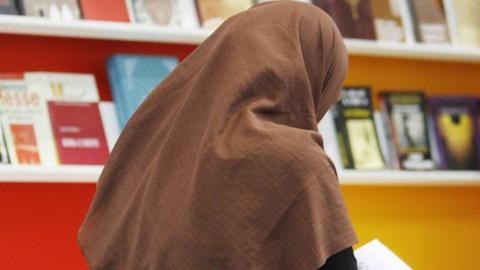 File pic of woman in library wearing headscarf