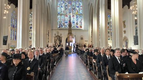 Congregation all in black at memorial service