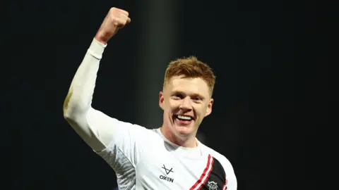 Lincoln's Sam Clucas celebrates his goal at Mansfield