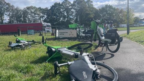 A view of an electric bike and scooter rack near Fabis Drive, in Clifton, with Lime bikes scattered on the floor in the foreground because the 