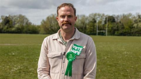 The Green Party's Rob Yates stood in a field.
