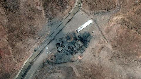A satellite image shows damaged infrastructure nestled in rocky terrain.