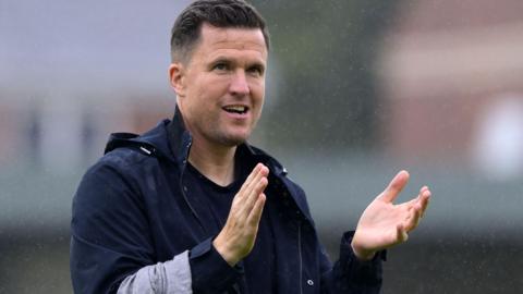 Gary Caldwell pictured on the touchline, clapping