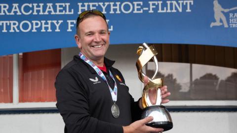 Andy Tennant holding the Rachael Heyhoe Flint Trophy 