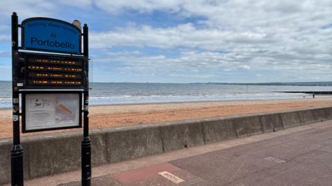 Portobello beach promenade with a blue sky above scattered with clouds 