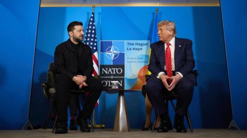 Ukrainian President Volodymyr Zelensky sits next to US President Donald Trump at the Nato summit in June 2025.