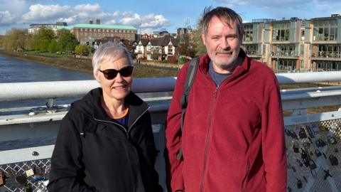 Gail Walder and Ryan Lunt standing next to each other on Wilford Suspension Bridge in Nottingham. 