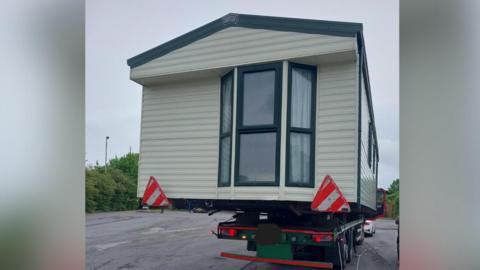 An image of a caravan transporter pulled over by police on the A1 near Grantham