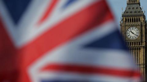 A Union flag flies near the Houses of Parliament