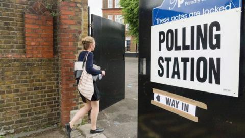 Woman walking into a polling station