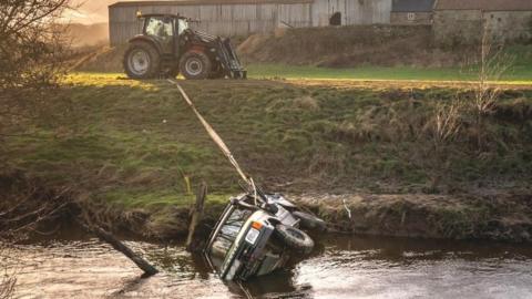 The recovered vehicle being removed from the River Esk near Glaisdale