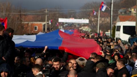 Ethnic Serbs carry a giant Serbian flag during a protest in near the ethnically-divided town of Mitrovica in Kosovo. Photo: 22 December 2022