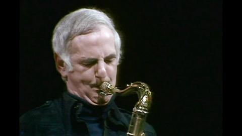 Ronnie Scott playing a saxaphone