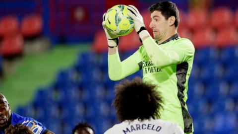 Thibaut Courtois makes a save for Real Madrid