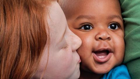 Girl kissing adopted sibling