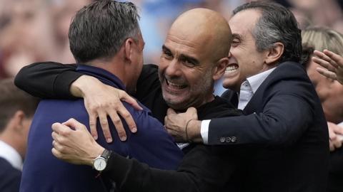 Pep Guardiola celebrates with his coaching staff