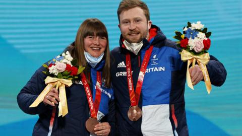 Millie Knight and Brett Wild with their bronze medals