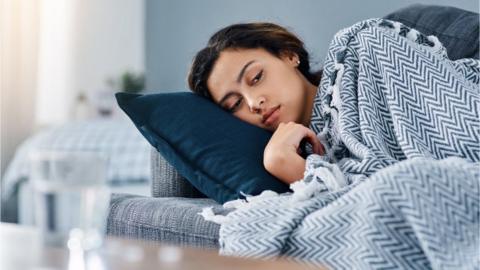 Woman lying on sofa