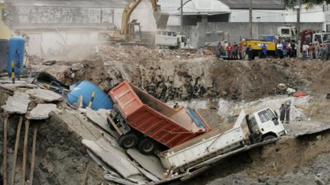 Trucks lay fallen over the rubble of the collapsed 'Pinheiros' subway station in Sao Paulo, Brazil 15 January 2007