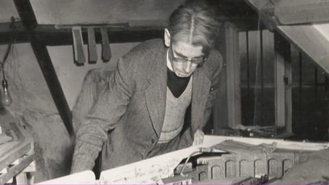 Wilbert Awdry looking down at the railway set he used to help plan his stories