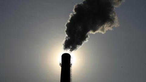 Smoke rises from a chimney in China