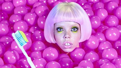 A woman in a pit of brightly coloured plastic balls.