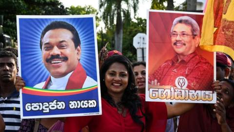 Supporters of Sri Lanka's President-elect Gotabaya Rajapaksa (right) wait near the election commission office in Colombo on November 17, 2019.