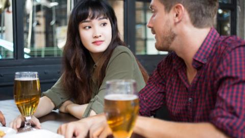 Models posing with glasses of beer