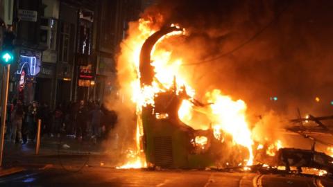 A bus on fire on O'Connell Street in Dublin city centre after violent scenes