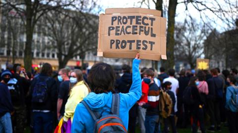 Demonstrators hold placards during a 'Kill The Bill' protest against the Government's Police, Crime, Sentencing and Courts Bill, in Bristol south west England on 30 March 2021