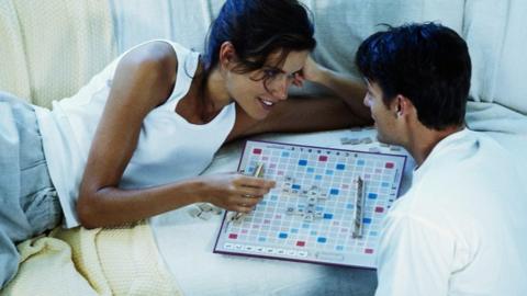 Couple playing Scrabble