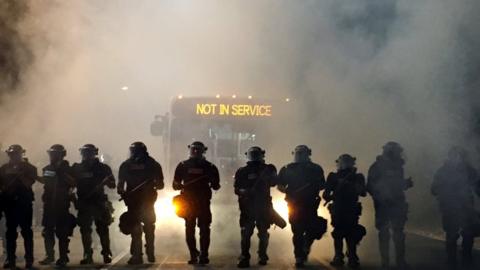 Police officers wearing riot gear block a road during protests after police fatally shot Keith Lamont Scott in the parking lot of an apartment complex in Charlotte, North Carolina, U.S. September 20, 2016