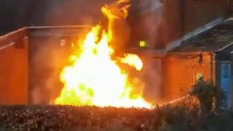 Firefighter putting out a burning bench