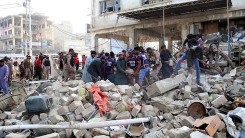 Rescuers work at the scene of the blast in Karachi, Pakistan. Photo: 18 December 2021