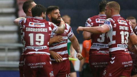 Wigan Warriors players congratulate Abbas Miski after a try against Huddersfield Giants