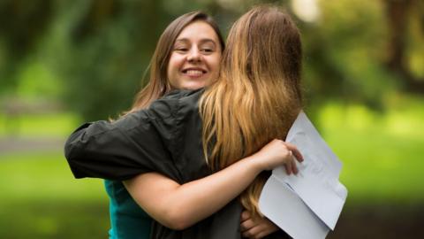 Caitlin Hannah hugs a fellow pupil after receiving 2 As and a A* in her A Level results at Ffynone House School in Swansea