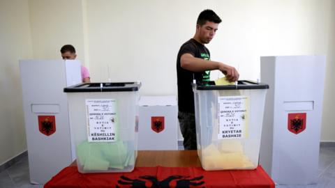 A man casts his ballot at a polling station near Tirana, Albania June 30