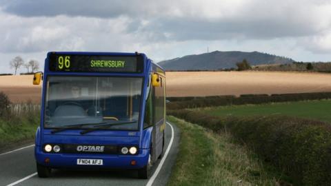A rural bus on a road in Shropshire